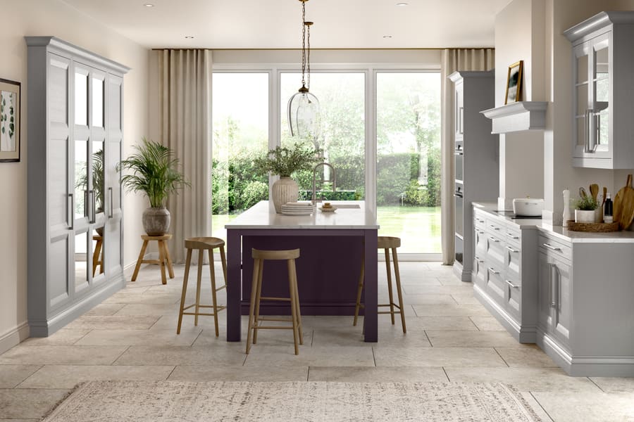 A light, open kitchen with garden doors, painted cabinetry and a breakfast bar