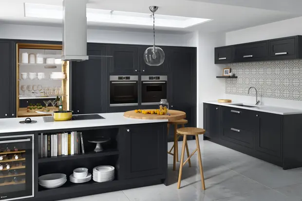 Dark navy cabinets and white quartz with a round oak butcher block