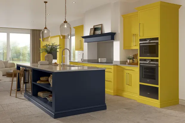 Bright yellow and midnight blue cabinets with grey worktops